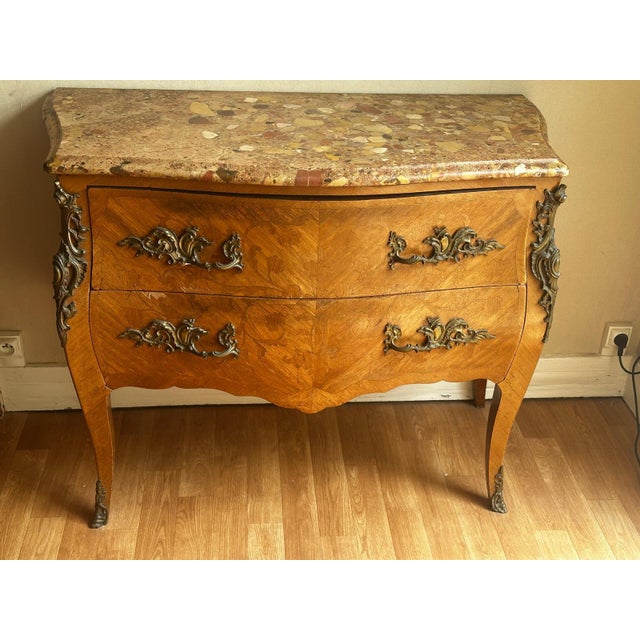 A louis xv style, 19th-century, bombé commode in marquetry, opening with two large drawers in the front. The decorative...