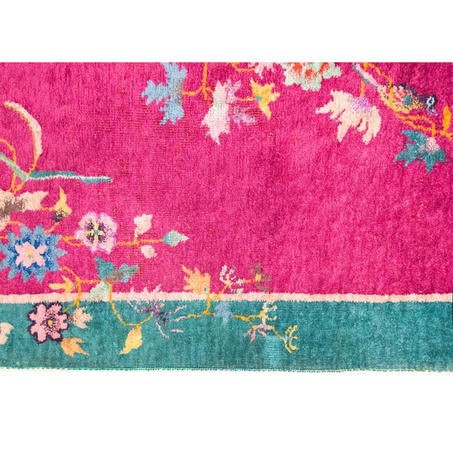 A wonderful early 20th century Chinese Art Deco rug with a fuchsia field surrounded by a wide turquoise border, and all...