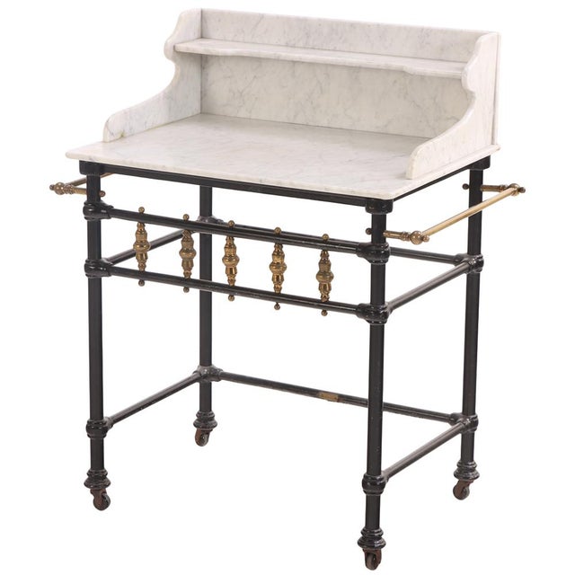 A highly functional late 19th-century iron and brass stand, acquired in Belgium and likely of French origin. This elegant...