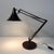 Brown hala desk lamp from the 1970s with adjustable arm and tulip-shaped shade in lacquered iron. The understated design...