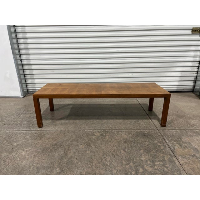 MCM c.1970s Lane Walnut Coffee Table. Crafted in rich walnut. Designed with two-tone grain pattern. A versatile addition...