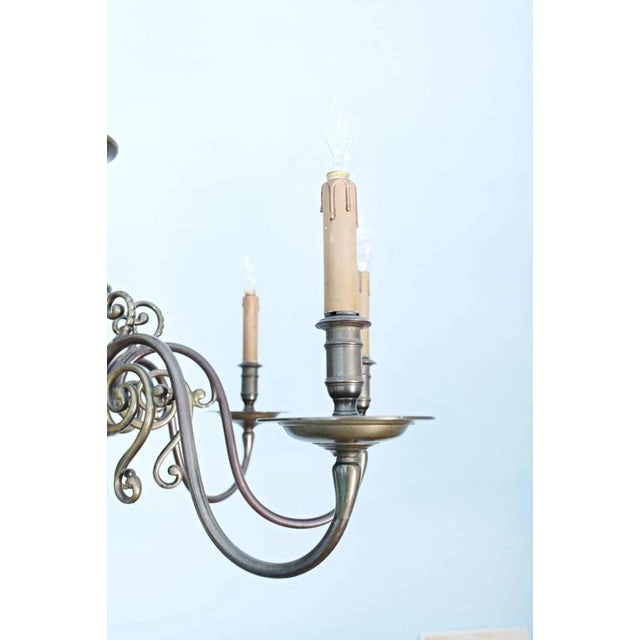 Heavy bronze chandelier with a beautiful patina. Eight-arm design. Checked and partially replaced electrical installation...
