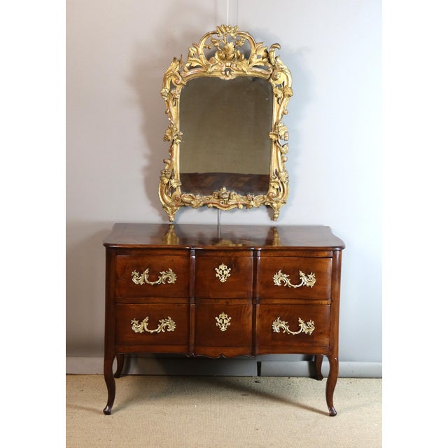 A Louis XV style commode in molded walnut with a bow-fronted top. This charming commode, characteristic of the Grenoble...
