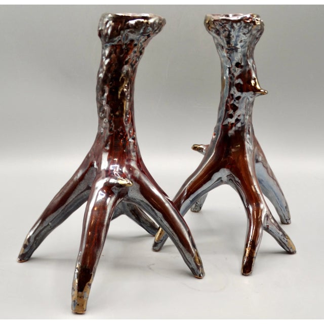A stunning pair of gleaming ceramic silver and brown faux antler horn candlesticks. These pretty candle holders are so...