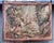 Charming 19th-century French tapestry depicting a pastoral landscape with a playful hunting scene. At the center of the...