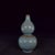 This elegant double-gourd shaped vase features soft sky-blue Ru-style celadon glaze with subtle crackle texture. Metal...