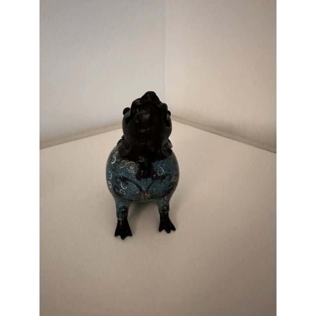 Enamelled dog cloisonné inkwell. Decorated with brightly colored designs. Bronzed head and feet.