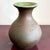 This bulbous ceramic vessel balances rustic simplicity with a subtle surprise. The unglazed exterior has a warm, earthy...