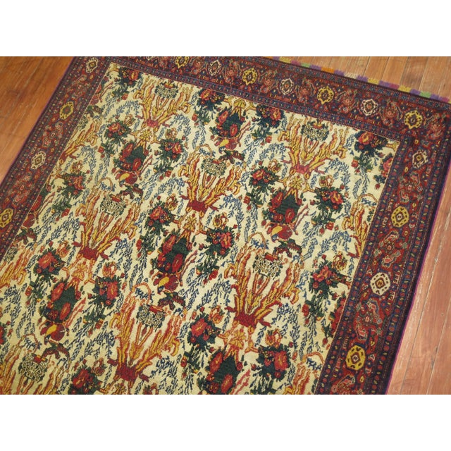 Spectacular 19th century Persian Senneh rug with a floral ivory design and enchanting formal border. The weaver added a...