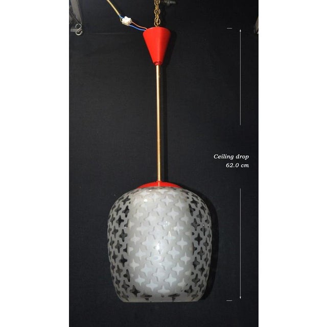 A striking mid-century german pendant light dating to circa 1960, distinguished by its sculptural double-glass shade and...