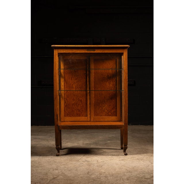 c. 1930s Vintage oak academic display case with adjustable glass shelves. This piece comes from a school district building...