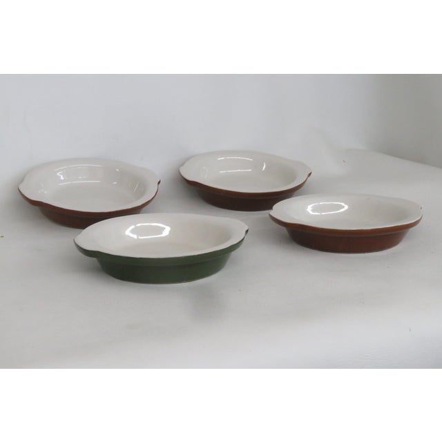 This charming Set of Four Crock Bowls is made of ceramic with a glossy finish. These beautiful small casserole dishes have...