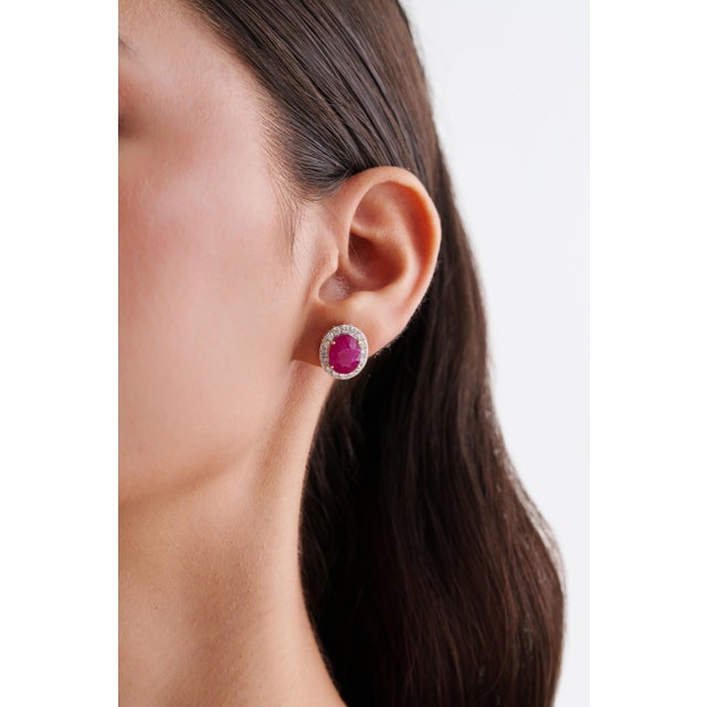 These classic stud earrings feature 7.21 carats of oval-cut ruby, set in 18K yellow gold. Each ruby measures approximately...
