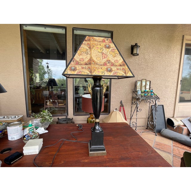 A stunning rare Empire style vintage lamp with an ebonised finish and brass accents. Crafted with attention to detail,...