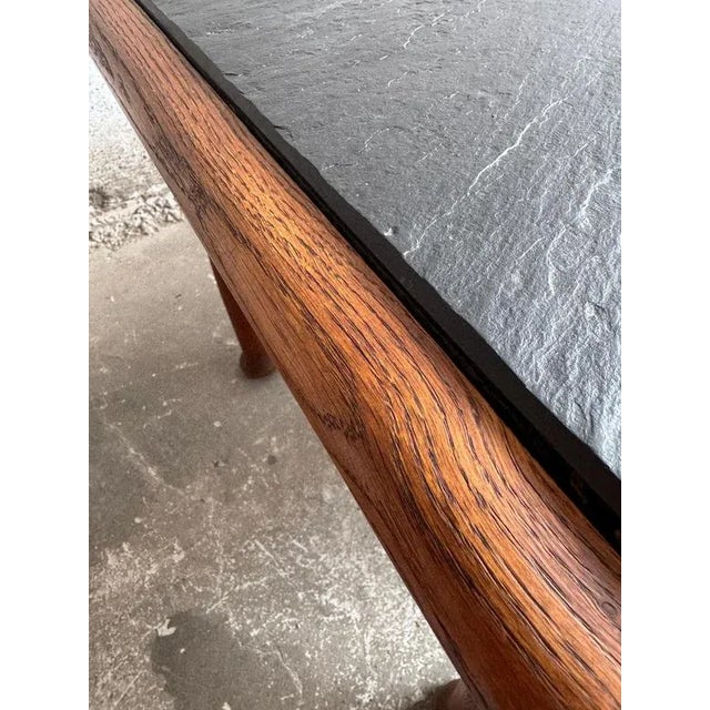 Vintage coffee table featuring a solid oak frame and a natural slate top—timeless, durable, and easy to style in any...