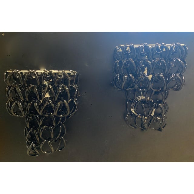 Pair of Murano wall lamps; Vistosi Company Each wall lamp has one E27 bulb holder. LED bulbs are recommended. The glass is...
