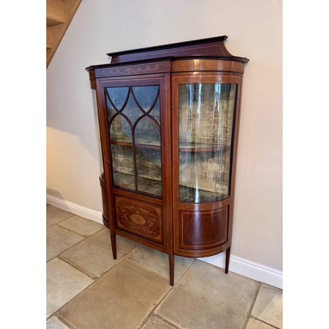 Elegant quality antique Edwardian mahogany inlaid bowfront display cabinet, having an elegant quality antique Edwardian...