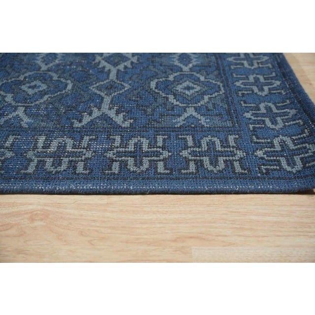 This blue wool rug is a hand knotted pile floor covering designed in the traditional Sarouk style. Originating from India,...