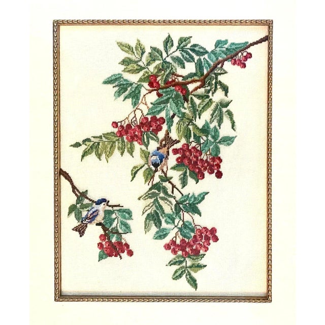 A gorgeous, custom framed needlepoint embroidery. Features two bluebirds ensconced in green leafed branches accented with...