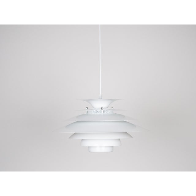 This lamp was designed by Danish designer Kurt Wiborg and manufactured by Jeka. The lamp's form is based on the principle...