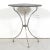A 19th century French cast iron bistro or garden table, circa 1880s, featuring a slate top resting on a painted iron tri-...