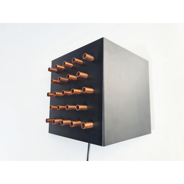 This very decorative wall lamp was designed and made by dutch company raak in the 1960's. The c-1516 is made of black...