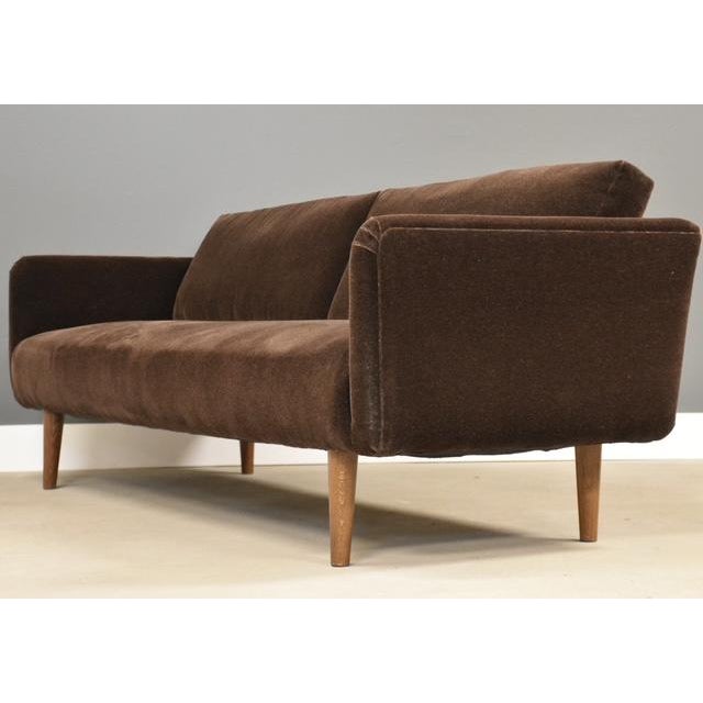 A mid century modern brown mohair sofa professionally reupholstered. Walnut color legs, very well made. Circa 1950’s. Made...