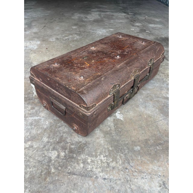 A striking antique British colonial steel cabin trunk from the early 20th century, presented in its original unpainted...