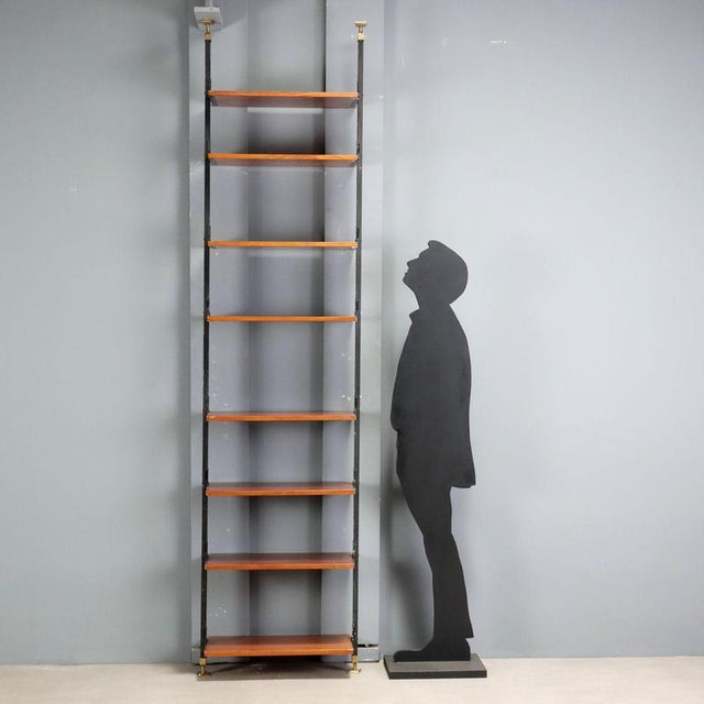 1960s floor-to-ceiling bookcase with a versatile and functional design. Made of mahogany veneer wood, it offers...