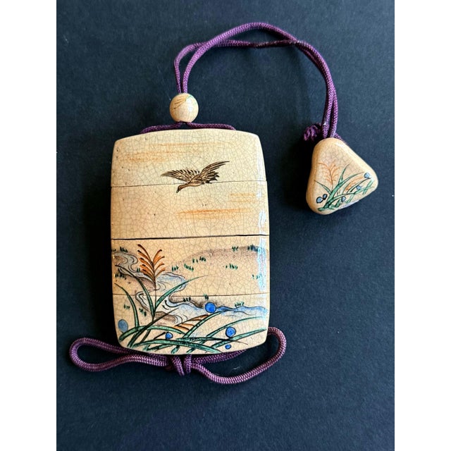 A Japanese four-section inro made from ceramic with glazed painting with original ensuite Ojime and Netsuke circa 18th...