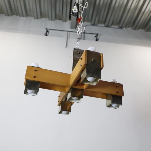 Circa 1960. We offer this Unusual Pair of mid-century modern wood & chrome hanging chandeliers. Each chandelier have 9...