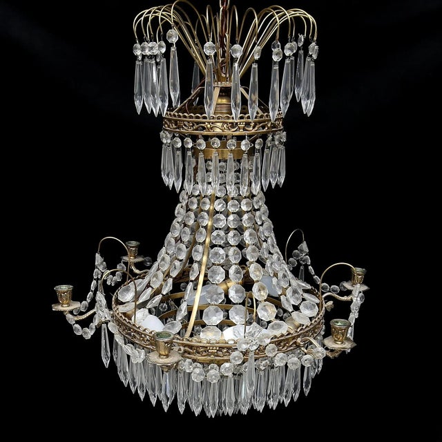 This prism chandelier has a height of 65 cm. There are six candle devices. The body was made of brass. Electrification...