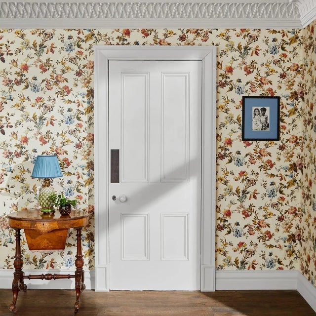 Blooming with chrysanthemums, daffodils, tulips and primroses, the ROSETTA wallpaper in 'Ecru' encompasses the verve and...