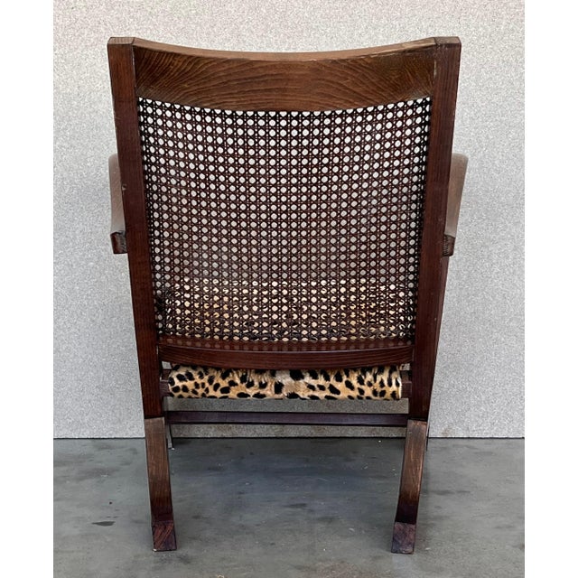 These very comfortable antique ladder back chairs with armrests were crafted in Spain, circa 1940. Built in walnut and...