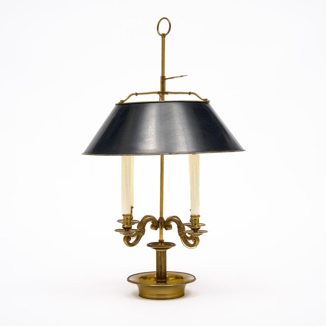 Bouillotte lamp from France in the French Empire style. This piece is made of finely cast bronze and features four...