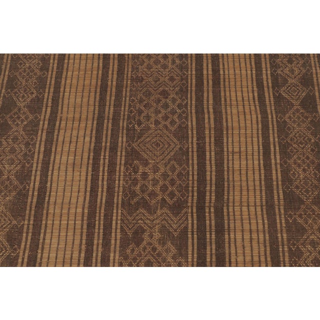 Made with handwoven reed and camel leather in Mauritania circa 1950-1960, this 4x5 vintage square Tuareg mat is an...