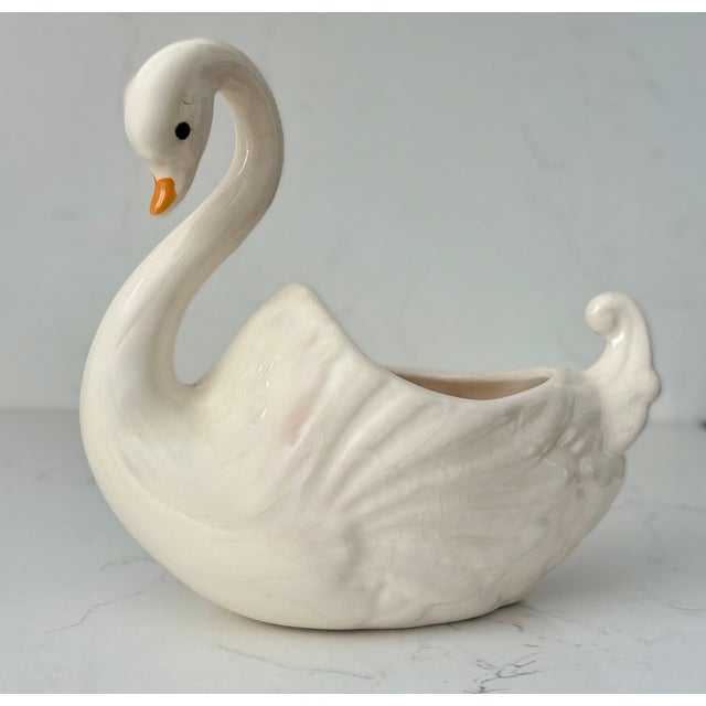 Graceful lines, unruffled feathers, glossy white surface.....oh yeah and it can hold a plant! This Vintage ceramic planter...