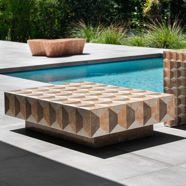 This hand-inlaid fossil stone and marble coffee table brings Fornasetti-inspired geometry to a living room, lounge or...