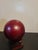 A vintage Japanese kokeshi doll. Made of wood with lovely hand carved detailing to the red body. Large head and wooden base.