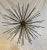 Large modern sputnik sculpture by Arteriors. Sculpture features 11 inch long aged silver metal rods. Rods screw into...