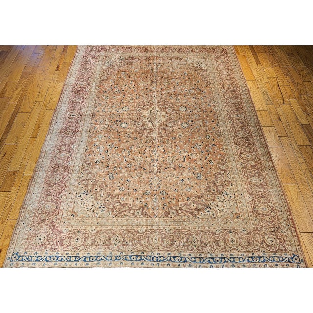 "Beautiful vintage Persian Tabriz hand-kontted rug circa the early 20th century. The rug features a serene pale apricot...