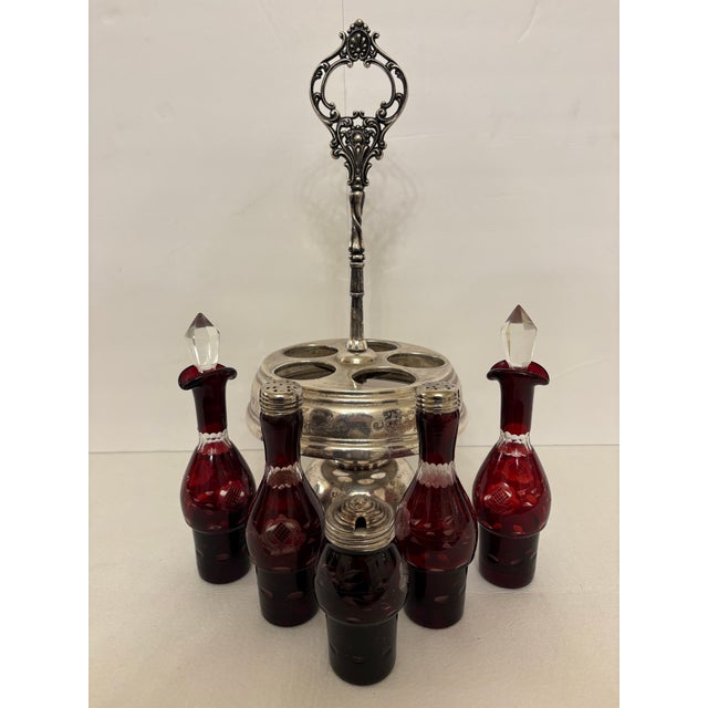 Add a striking pop of color to your dining table or sideboard with this exquisite VIctorian-era ruby glass condiment cruet...