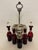 Add a striking pop of color to your dining table or sideboard with this exquisite VIctorian-era ruby glass condiment cruet...