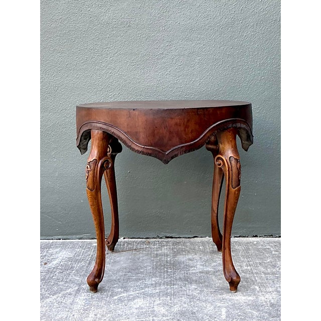 This exquisite side table is a masterful example of French Provincial design, featuring a striking round top with a rich...