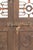 This Vintage Indian Carved Teakwood and Iron Door is a striking architectural piece that beautifully combines the warmth...