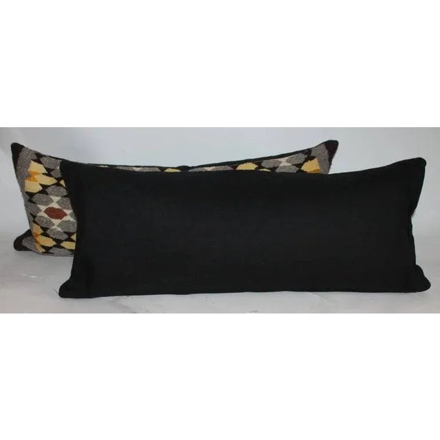 Pair of geometric woven pillows in fine condition and have black cotton linen backing.