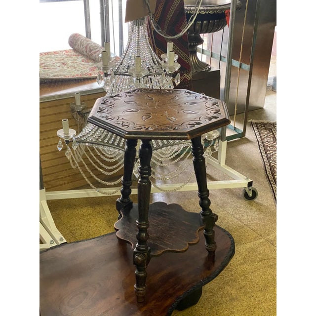 Lots of Patina on this mid 19th Century English carved side table. Tripod style with unique shape to top and lower shelf....