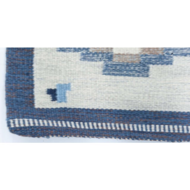Vintage Swedish blue flat woven rug by Erik Lundberg Size: 6'5" × 9'9" (195 × 297 cm) Celebrate the clean sophistication...