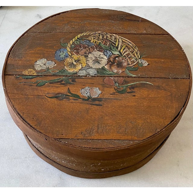 Vintage wooden round cheese box with lid and hand painted flowers in a basket on the top. Inside has a green liner added...