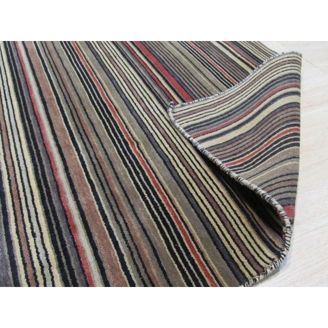 This multicolor jewel tone rug is constructed from wool using a traditional hand knotted pile weave. It falls under the...